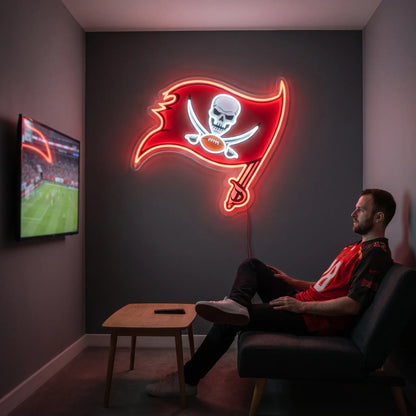 A man holding a large flag-shaped Tampa Bay Buccaneers NFL football team logo LED neon sign