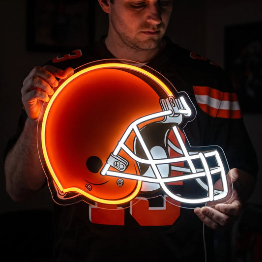 A man holding a large Cleveland Browns NFL football team helmet LED neon sign