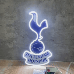 Close-up view of the illuminated Tottenham Hotspur FC LED Neon crest featuring the cockerel and team name