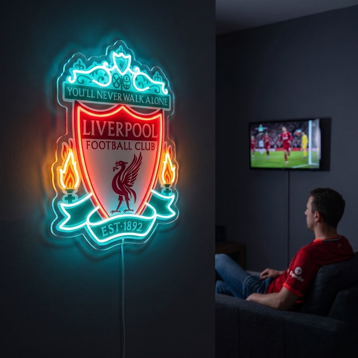 Liverpool FC logo LED neon sign mounted on a wall, glowing brightly in red and teal in a dark room.