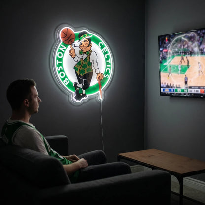 A man holding a large Boston Celtics NBA basketball team logo LED neon sign