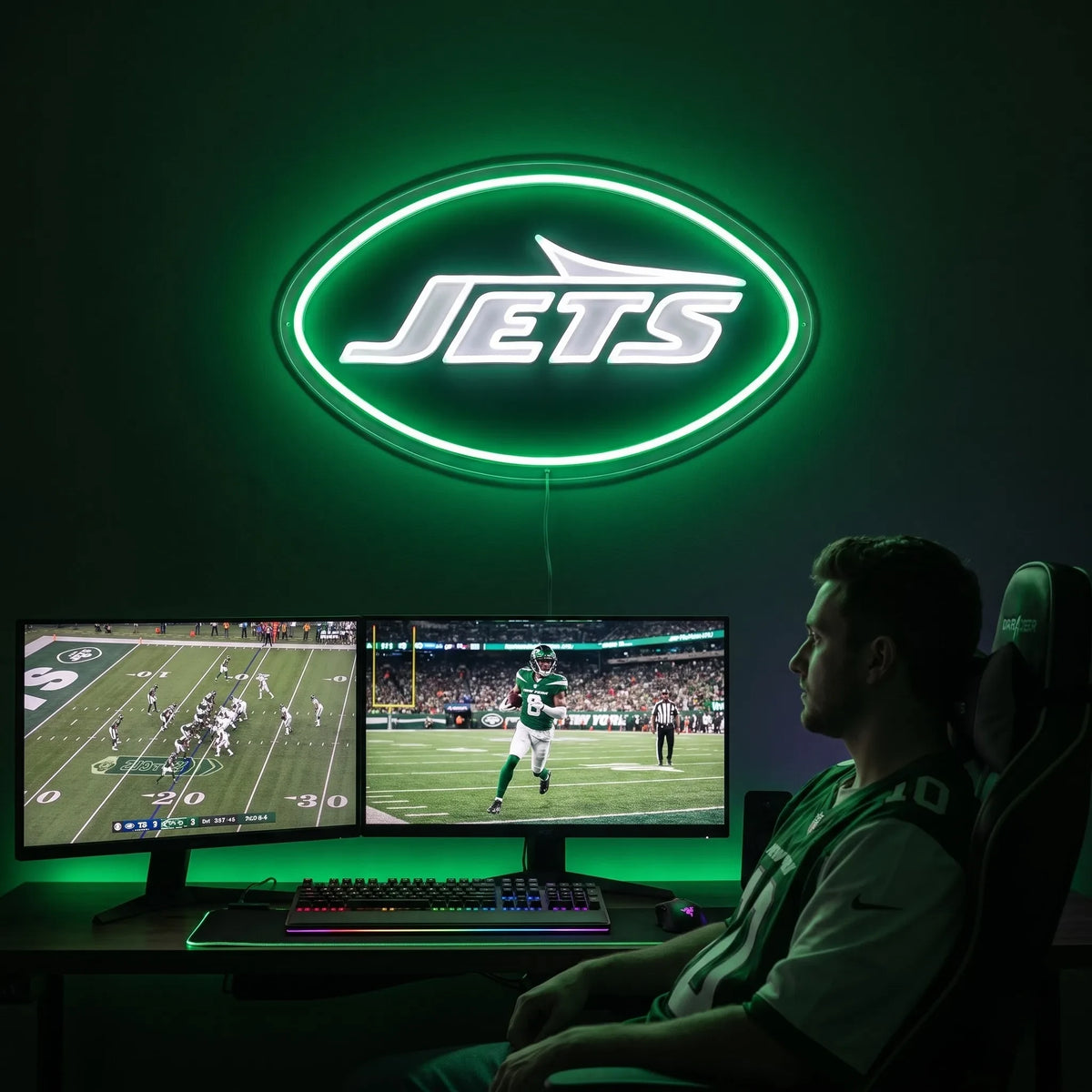 A man holding a large oval-shaped New York Jets NFL football team logo LED neon sign featuring the bold white JETS wordmark and airplane silhouette shape surrounded by a glowing vibrant green light border
