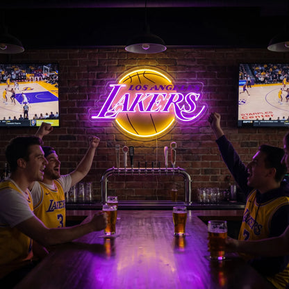 A woman holding a large glowing yellow and purple Los Angeles Lakers NBA basketball team LED neon sign
