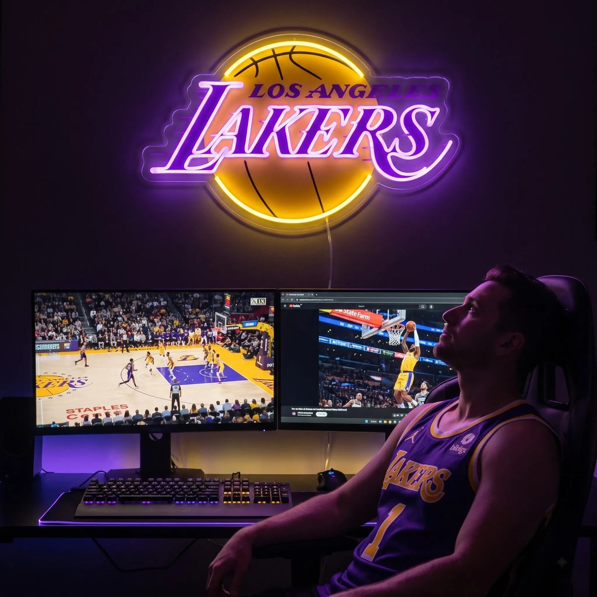 A woman holding a large glowing yellow and purple Los Angeles Lakers NBA basketball team LED neon sign