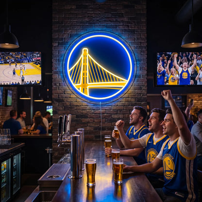 A smiling woman holding a round glowing blue and yellow Golden State Warriors NBA basketball team LED neon sign featuring the Bay Bridge logo