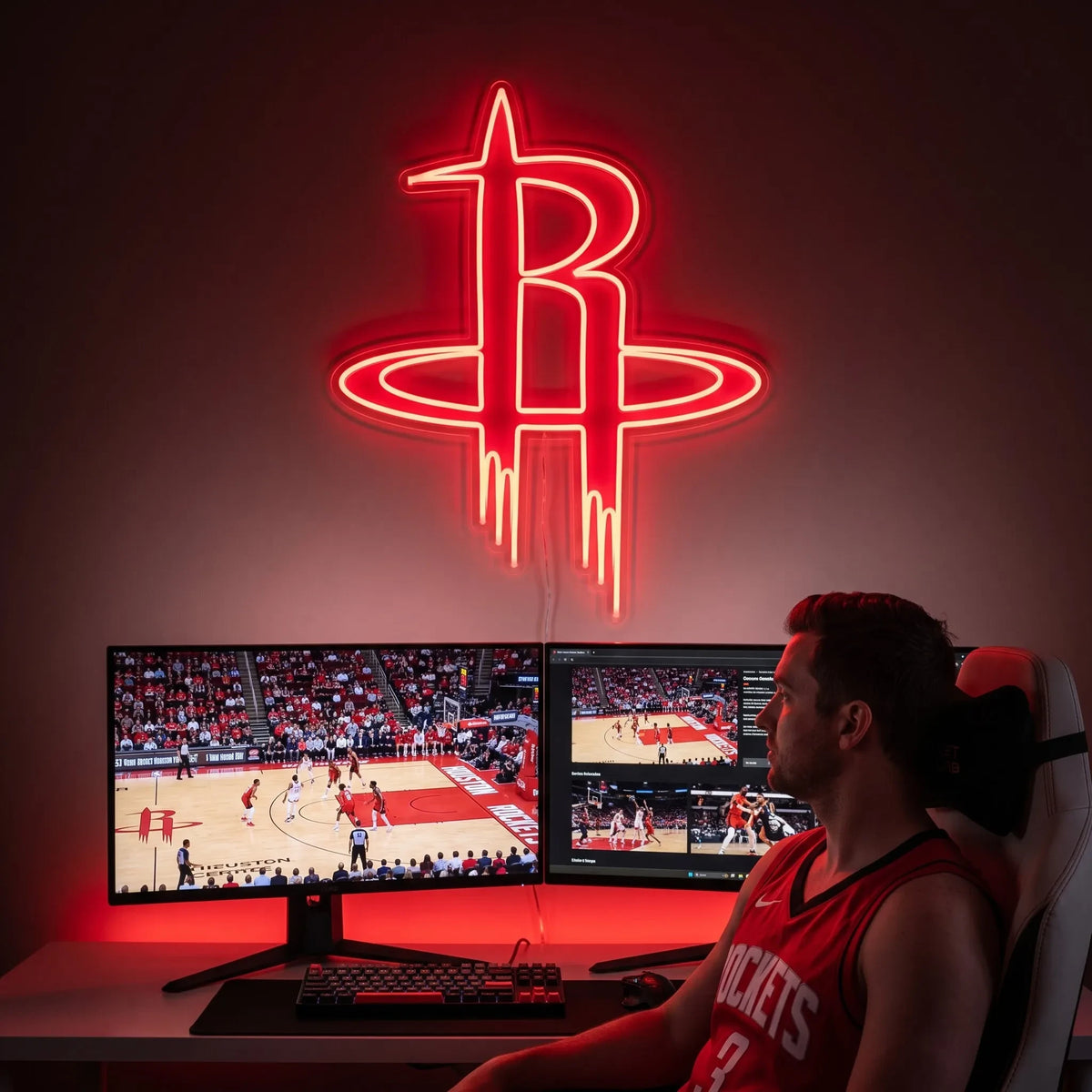 A smiling woman holding a large glowing red Houston Rockets NBA basketball team R logo LED neon sign